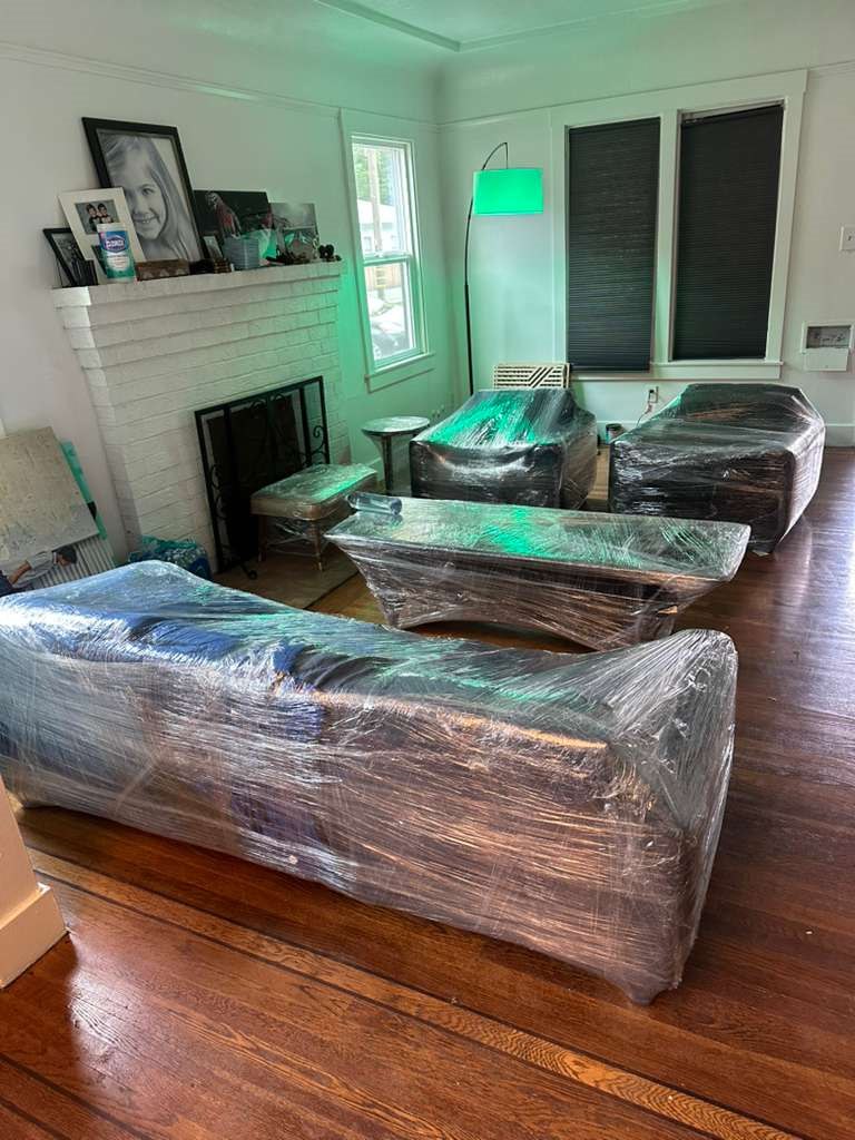Wrapped sofas and tables in a living room