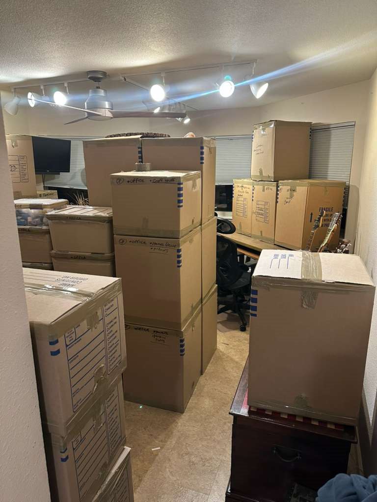 Room packed with labeled moving boxes